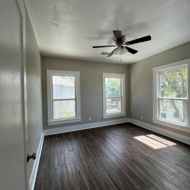 unfurnished room featuring a textured ceiling, dark hardwood / wood-style flooring, and ceiling fan