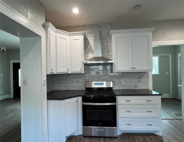 kitchen with white cabinets, dark hardwood / wood-style flooring, stainless steel stove, and wall chimney exhaust hood