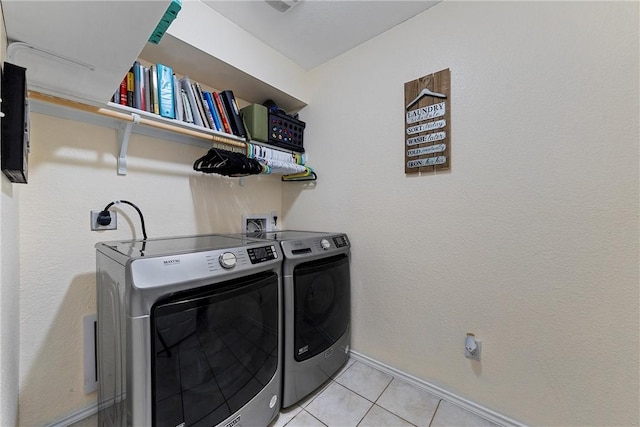 laundry area featuring separate washer and dryer and light tile patterned floors