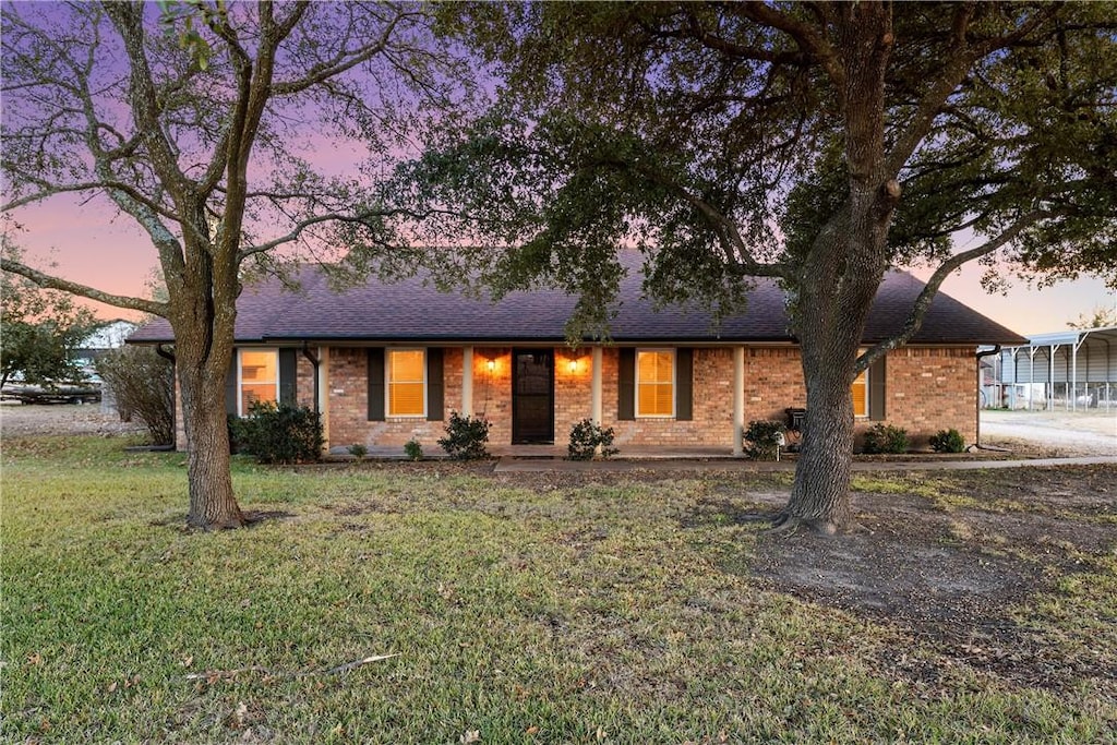 ranch-style house with a lawn