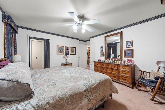 bedroom featuring ornamental molding, a ceiling fan, and light carpet