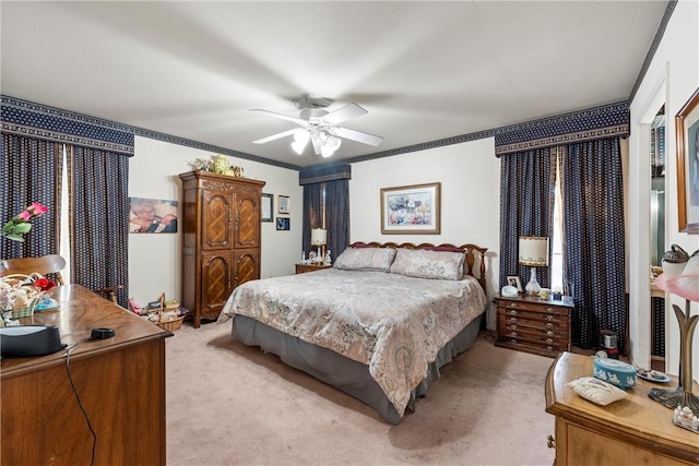 bedroom with crown molding, light colored carpet, and ceiling fan