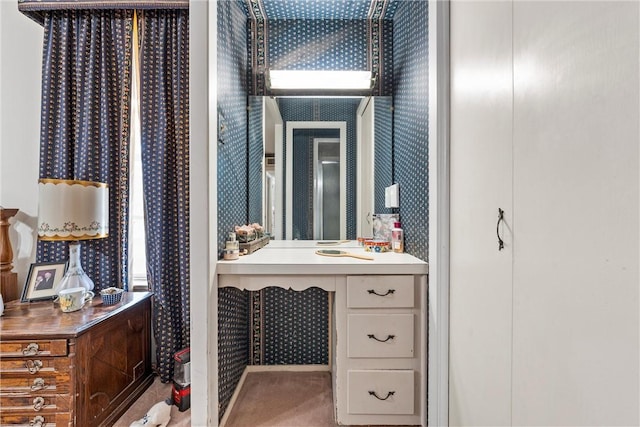 bathroom with a sink and wallpapered walls