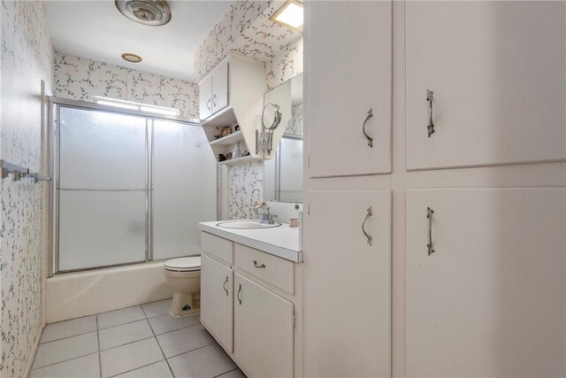 full bathroom featuring wallpapered walls, toilet, vanity, and tile patterned flooring