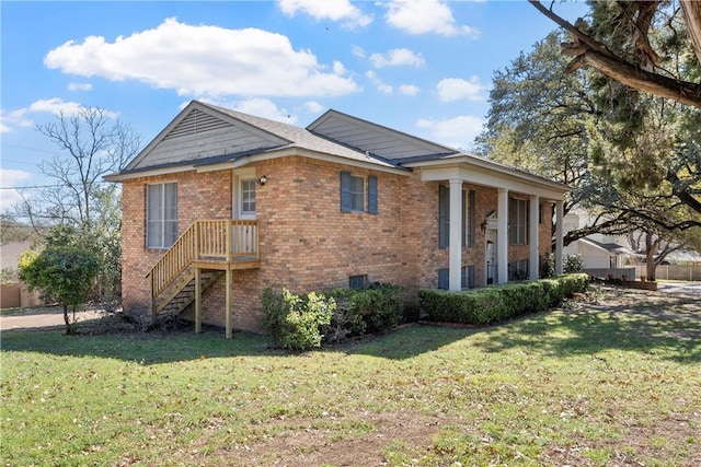 view of front facade featuring a front yard and brick siding