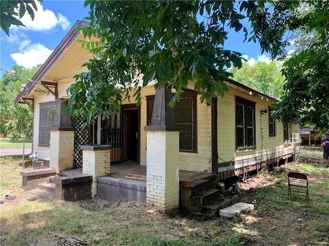 view of property exterior featuring covered porch