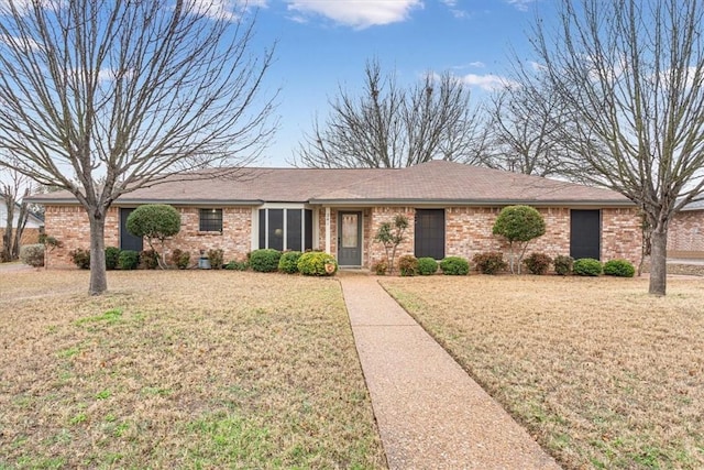 ranch-style home with a front lawn