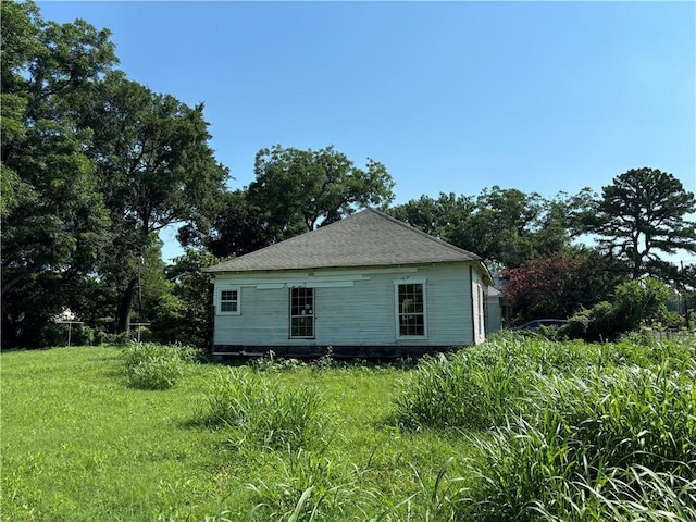 view of side of property featuring a yard