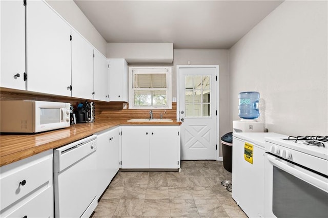 kitchen featuring white cabinetry, white appliances, and sink