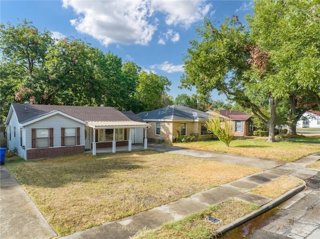 ranch-style home with a front lawn and a porch