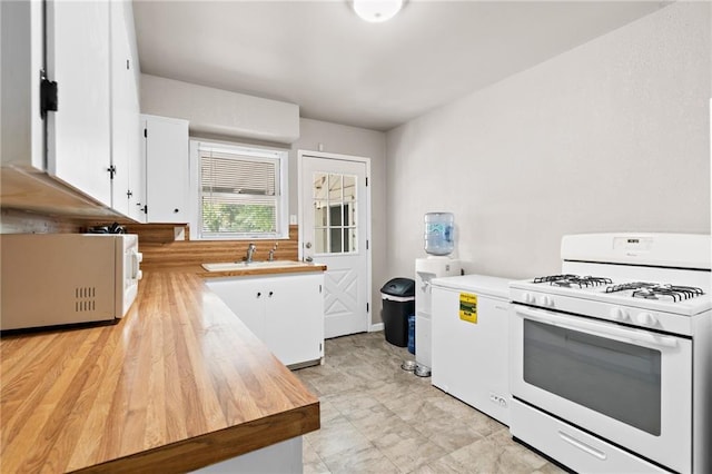 kitchen featuring sink, white appliances, and white cabinets