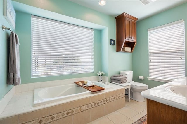 bathroom featuring tile patterned flooring, vanity, toilet, and a wealth of natural light