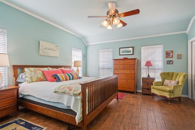 bedroom with ceiling fan, vaulted ceiling, dark hardwood / wood-style flooring, and multiple windows