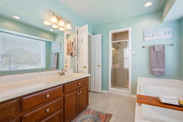 bathroom with tile patterned flooring, vanity, and shower with separate bathtub