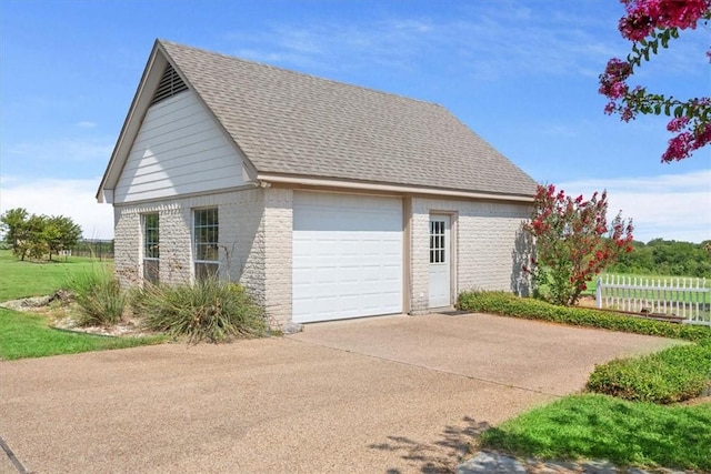 view of side of home with an outdoor structure and a garage