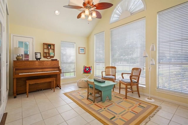 living area with plenty of natural light, ceiling fan, light tile patterned floors, and high vaulted ceiling