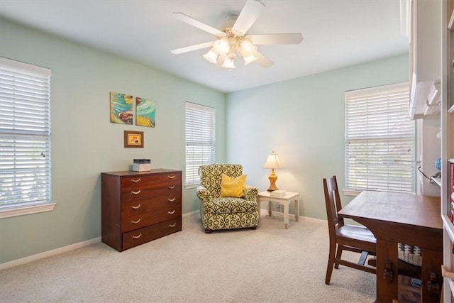 carpeted office featuring ceiling fan and a healthy amount of sunlight