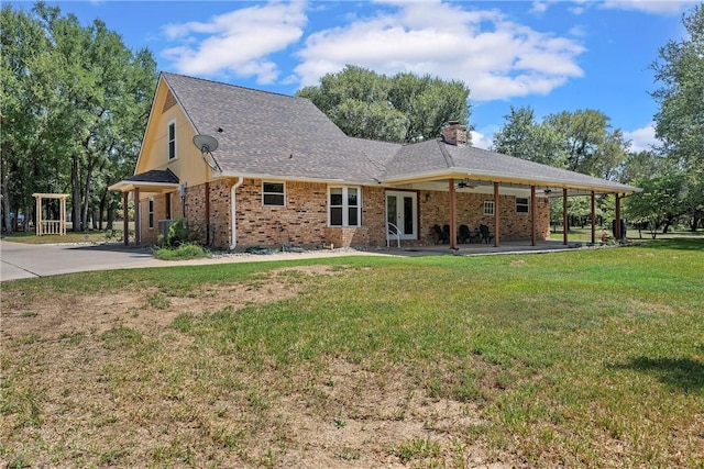 rear view of property with a lawn