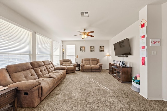 carpeted living room featuring ceiling fan and plenty of natural light