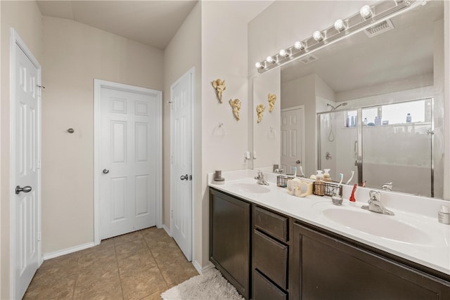 bathroom featuring tile patterned flooring, vanity, and walk in shower