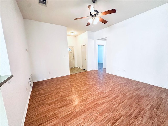 empty room featuring ceiling fan and light hardwood / wood-style flooring