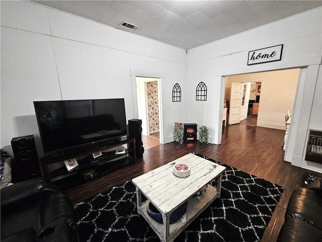 living room with dark hardwood / wood-style floors and heating unit