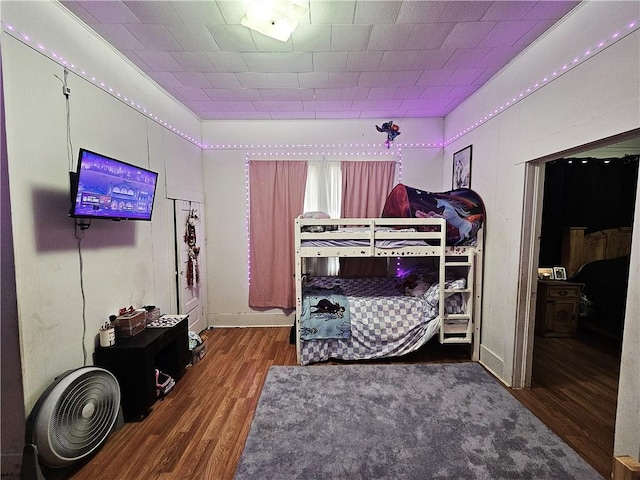 bedroom with dark hardwood / wood-style flooring