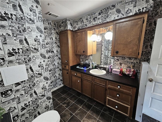 bathroom with vanity, tile patterned floors, and toilet