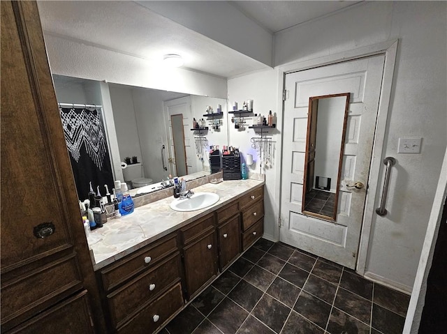 bathroom with vanity, curtained shower, tile patterned floors, and toilet