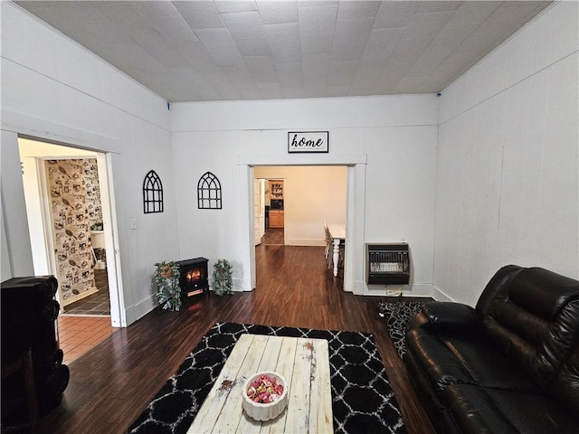 living room featuring dark hardwood / wood-style flooring and heating unit