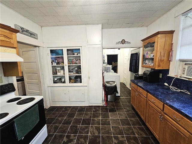 kitchen featuring washer / clothes dryer and electric range