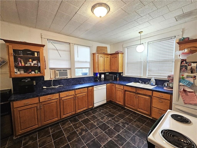 kitchen featuring cooling unit, sink, white appliances, and pendant lighting