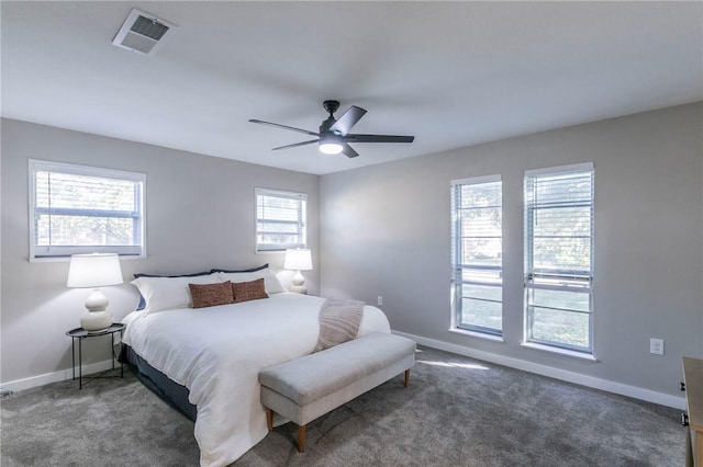 bedroom with ceiling fan and dark carpet