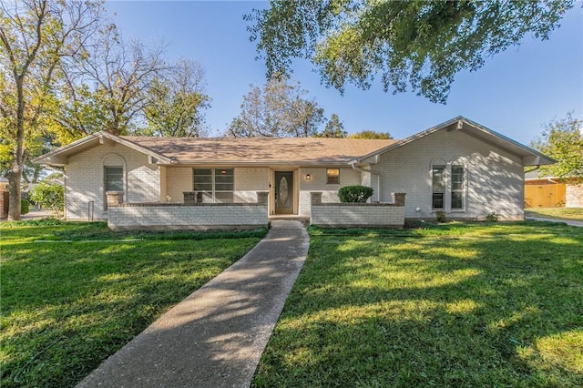 ranch-style home with a front lawn