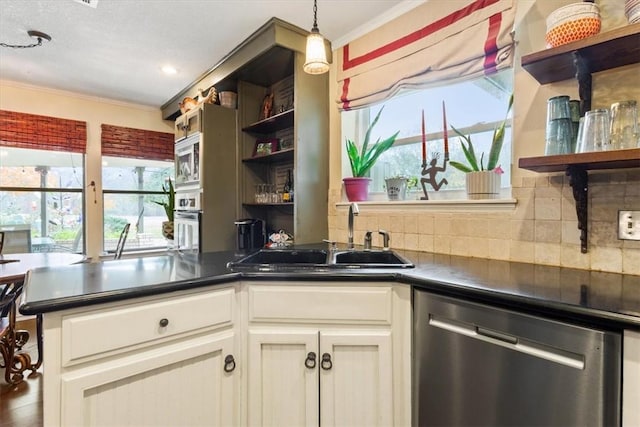 kitchen with decorative backsplash, a healthy amount of sunlight, sink, and appliances with stainless steel finishes