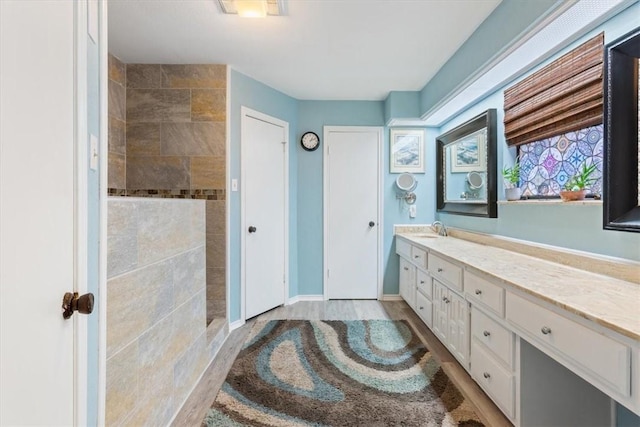 bathroom with hardwood / wood-style flooring and vanity