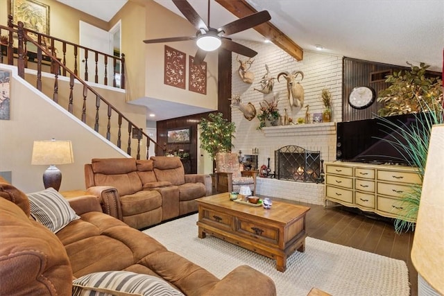 living room featuring ceiling fan, beamed ceiling, high vaulted ceiling, hardwood / wood-style floors, and a fireplace