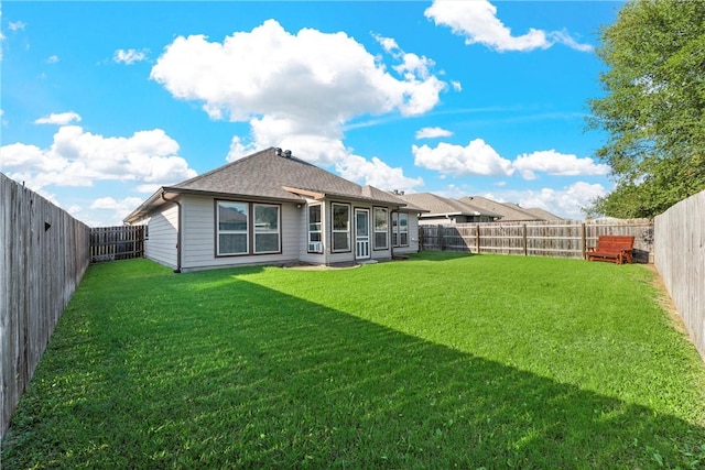 rear view of house with a lawn