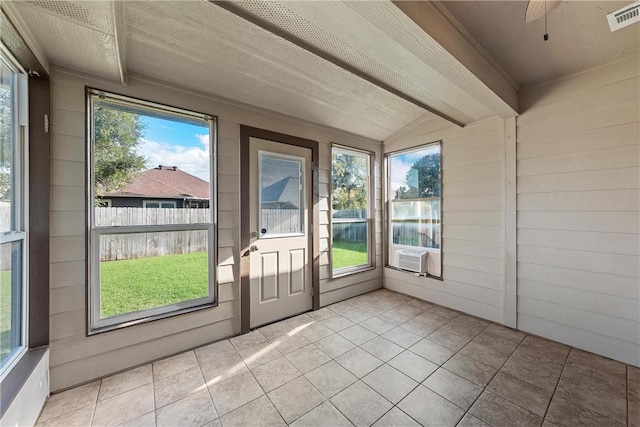 unfurnished sunroom featuring a wealth of natural light, cooling unit, and lofted ceiling with beams