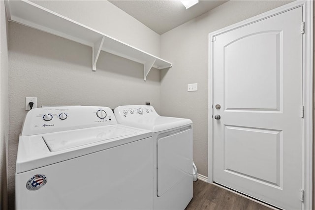 washroom with a textured ceiling, dark hardwood / wood-style flooring, and separate washer and dryer