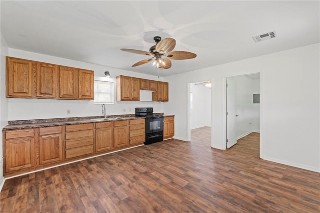 kitchen with dark hardwood / wood-style flooring, black range with electric stovetop, ceiling fan, and sink