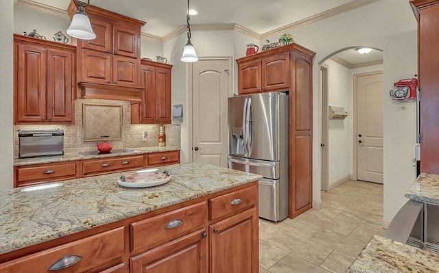 kitchen with black stovetop, pendant lighting, stainless steel refrigerator with ice dispenser, and ornamental molding