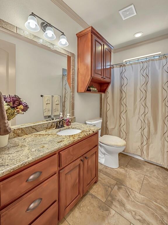 bathroom featuring vanity, toilet, and ornamental molding