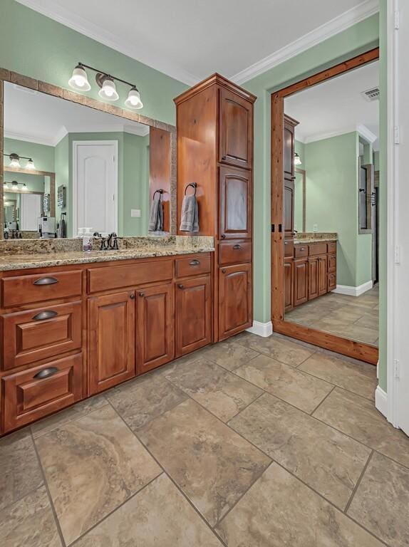 bathroom with crown molding and vanity