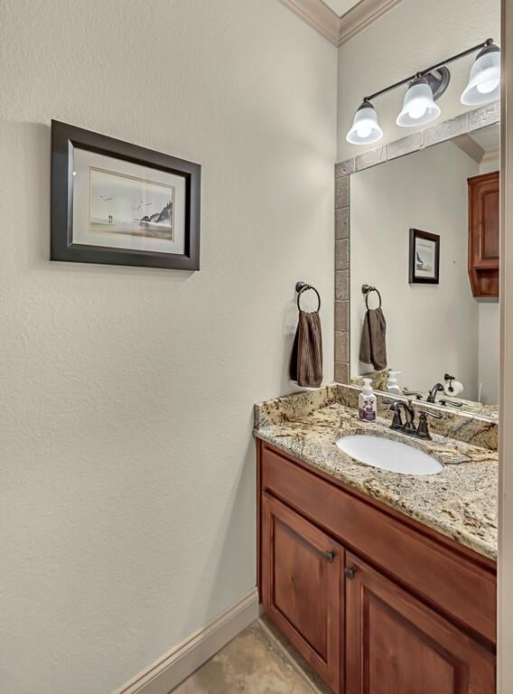 bathroom with vanity and crown molding