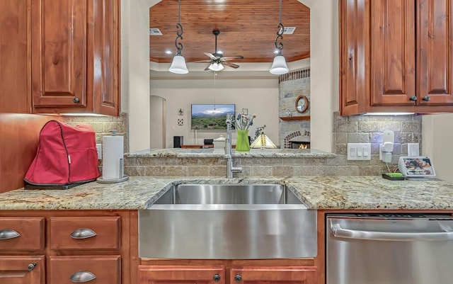 kitchen with ceiling fan, sink, light stone counters, stainless steel dishwasher, and decorative backsplash