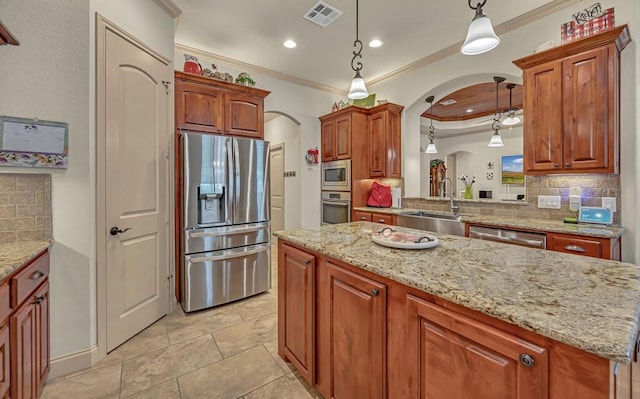 kitchen with backsplash, ornamental molding, stainless steel appliances, sink, and decorative light fixtures