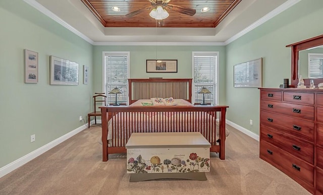 carpeted bedroom featuring a raised ceiling, multiple windows, and ceiling fan