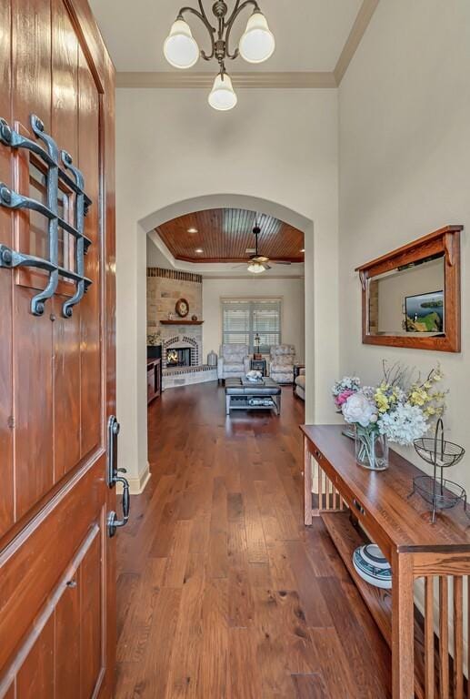 corridor with ornamental molding and hardwood / wood-style flooring