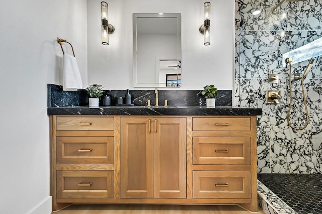 bathroom featuring vanity, walk in shower, and ceiling fan